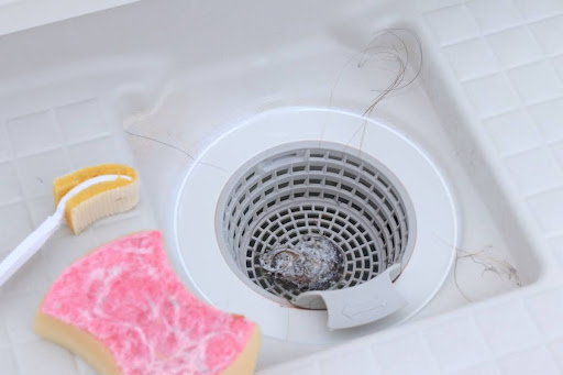 A hair catcher in a drain.