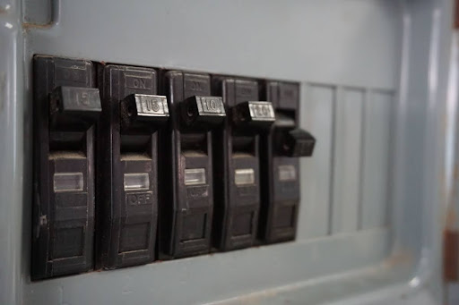 A close-up of the circuit breakers on an electrical panel in a home.
