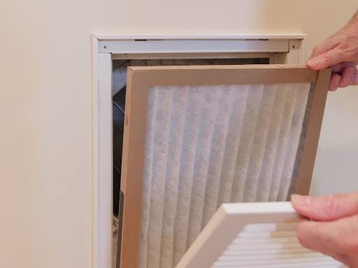 A furnace air filter being installed.