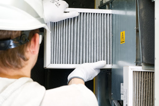 Gillece technician replacing air filter.